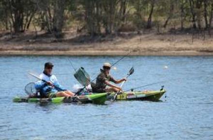 Two people Paddling in canoes at Kurwongbah