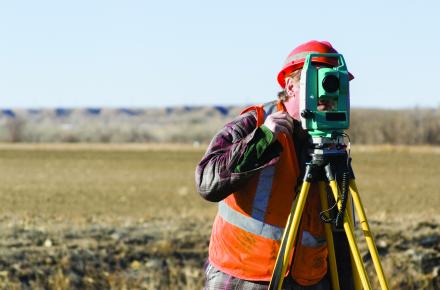Worker in hivis conducing a technical survey