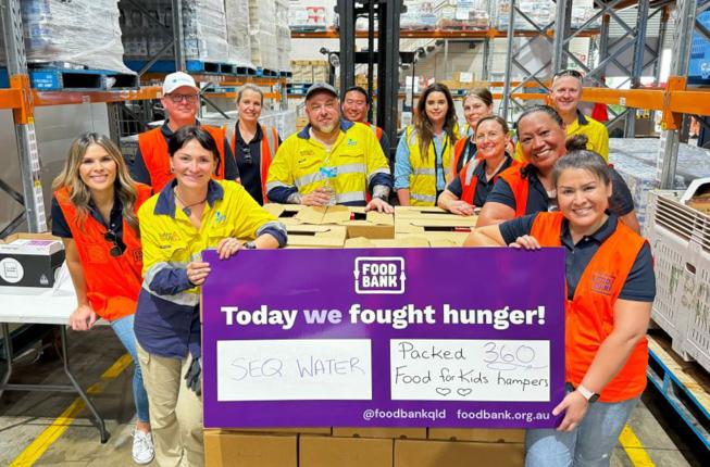 Seqwater staff volunteering at Foodbank to pack hampers